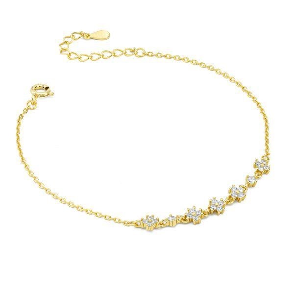 Bracciale dorato con con fiori definiti da zirconi